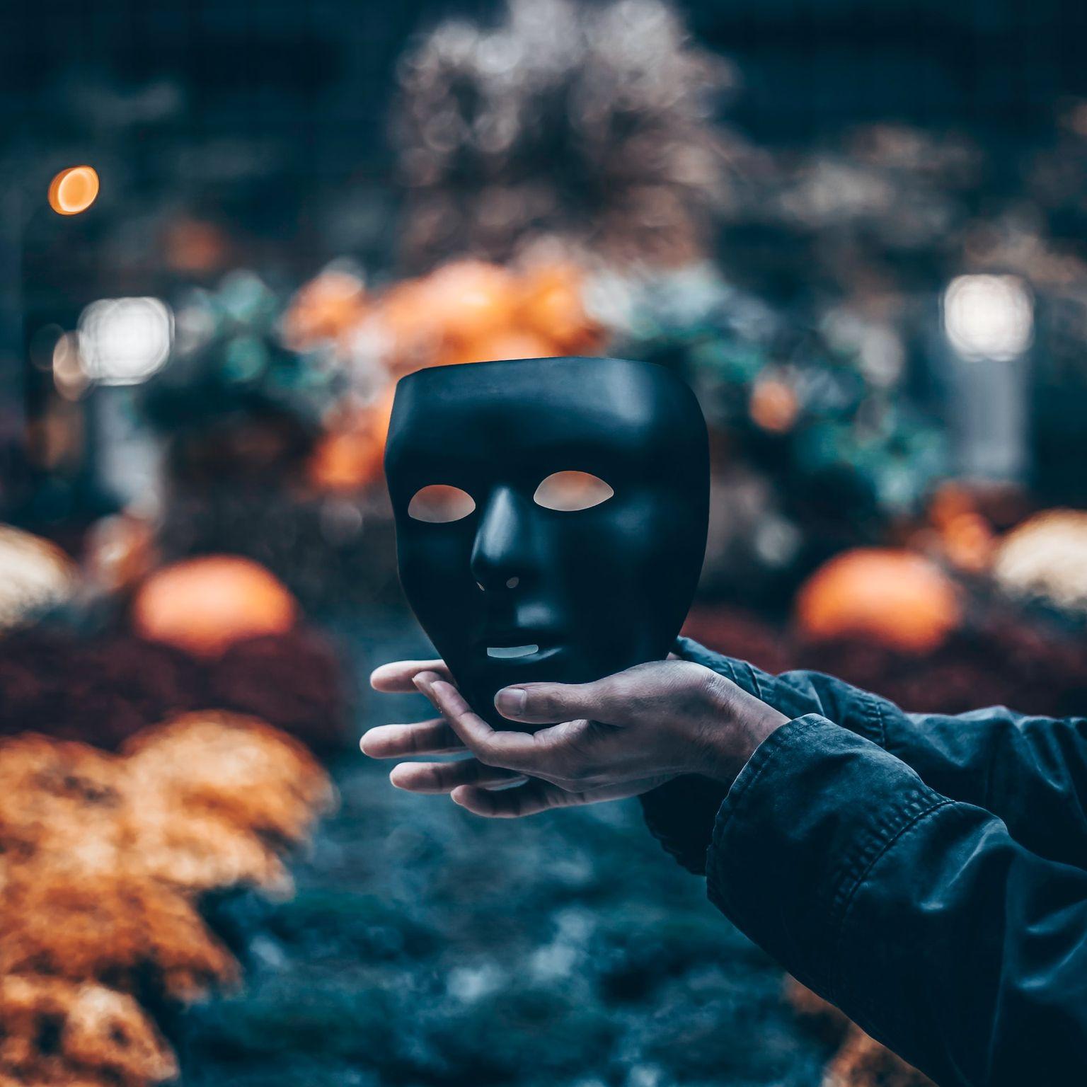 person holding black mask